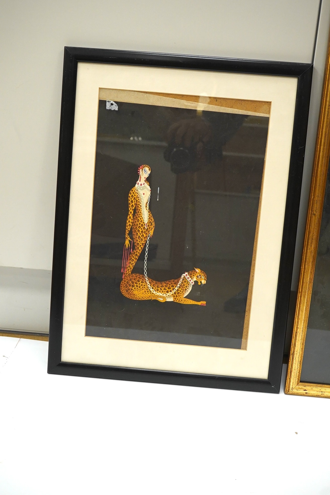 After Romain de Tirtoff (Erté, 1892-1990), two colour prints, Art Deco female with leopard and dancing figure, largest 53 x 39cm. Condition - fair, one loose within the frame